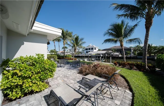 a view of backyard of house with outdoor seating