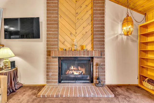 a living room with furniture fireplace and a flat screen tv