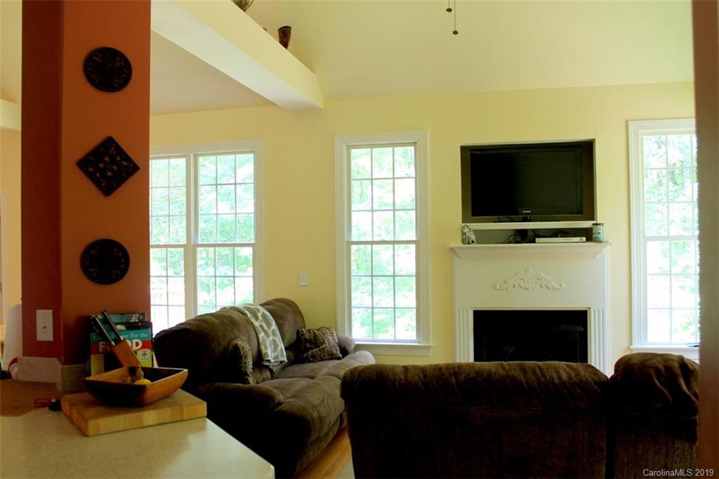 220 Beechtree Circle Rutherfordton, NC 28139 - Photo 12 of 26 a living room with furniture a flat screen tv and a fireplace