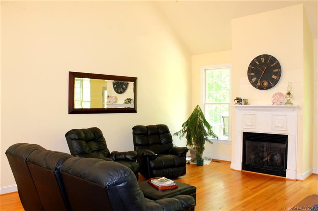 220 Beechtree Circle Rutherfordton, NC 28139 - Photo 7 of 26 a living room with furniture a fireplace and a large window