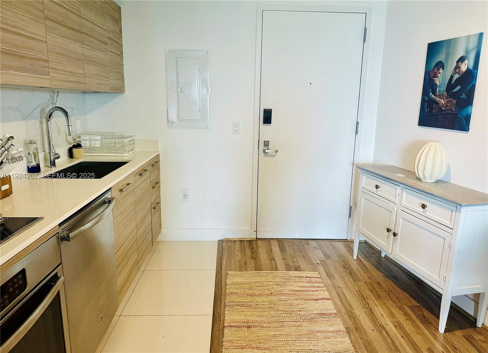 121 Northeast 34th Street, Unit 3014 Miami, FL 33137 - Photo 18 of 54 a kitchen with a sink and cabinets