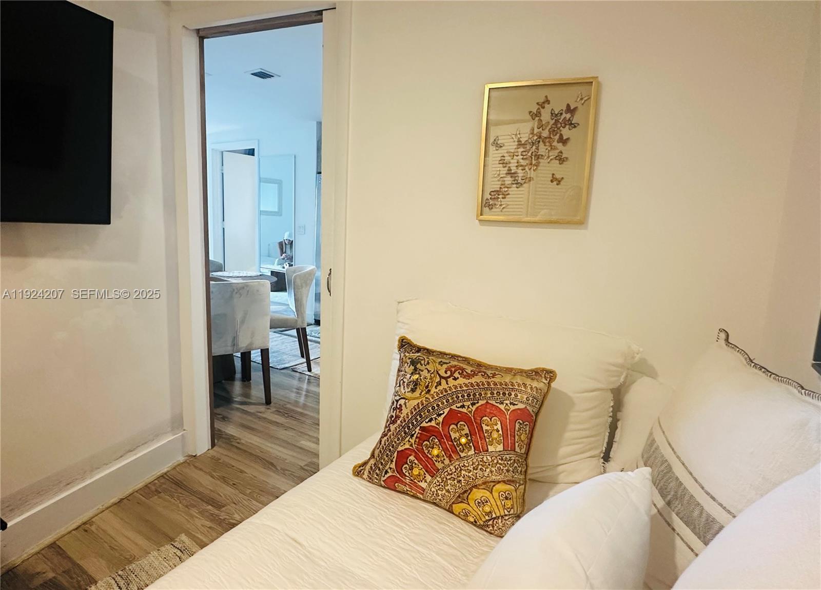 121 Northeast 34th Street, Unit 3014 Miami, FL 33137 - Photo 21 of 54 a living room with furniture and a flat screen tv