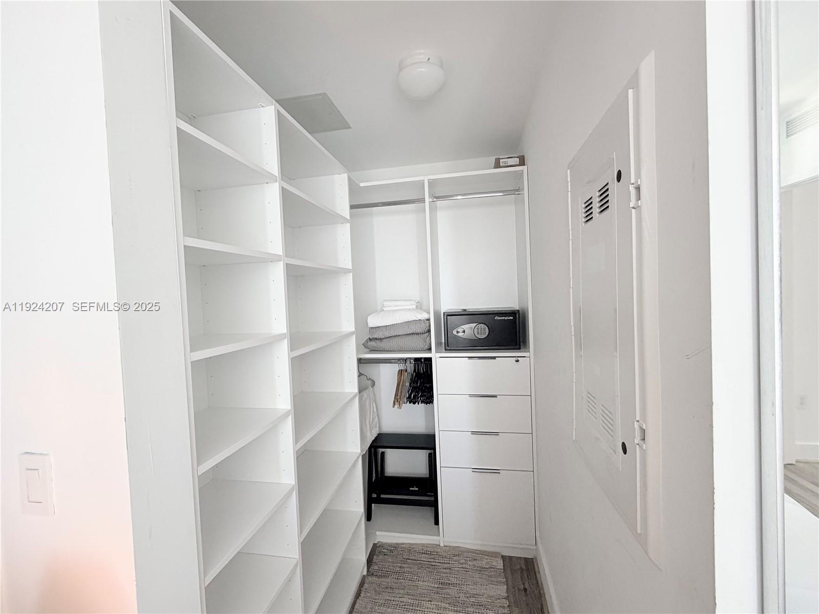 121 Northeast 34th Street, Unit 3014 Miami, FL 33137 - Photo 31 of 54 a view of walk in closet with empty racks
