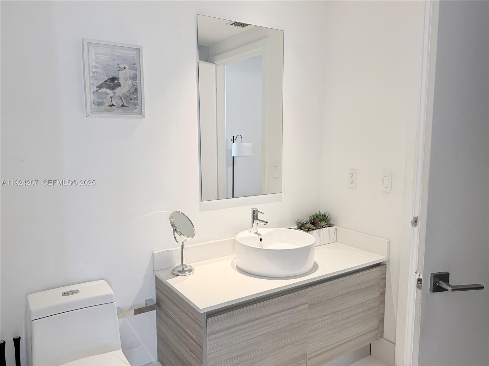 121 Northeast 34th Street, Unit 3014 Miami, FL 33137 - Photo 34 of 54 a bathroom with a sink and a toilet