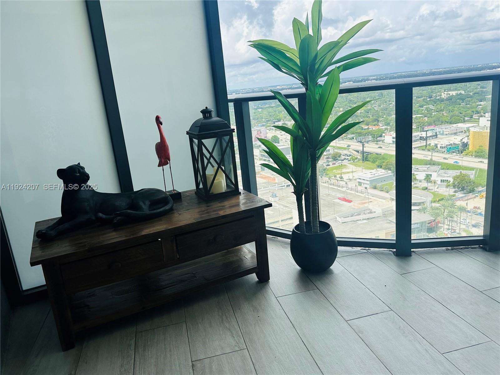 121 Northeast 34th Street, Unit 3014 Miami, FL 33137 - Photo 36 of 54 a living room with furniture and a potted plant