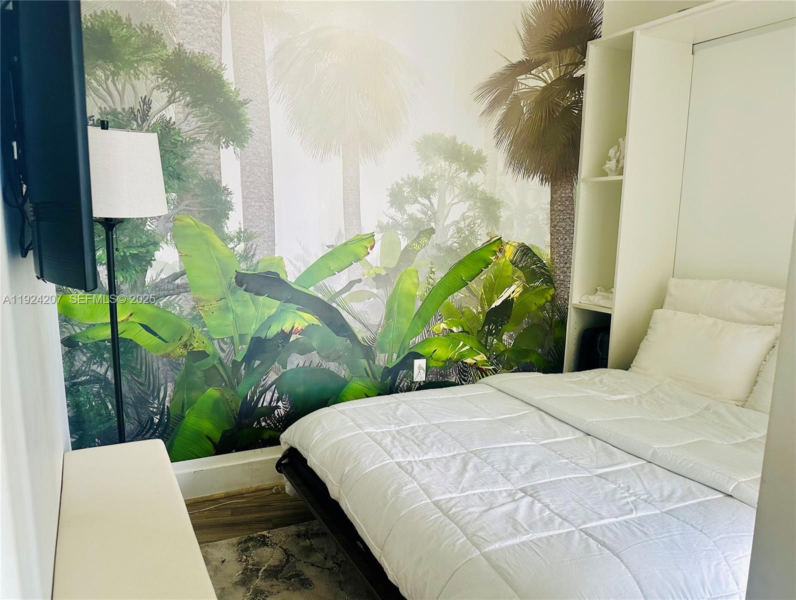 121 Northeast 34th Street, Unit 3014 Miami, FL 33137 - Photo 39 of 54 a bed sitting in a bedroom next to a window