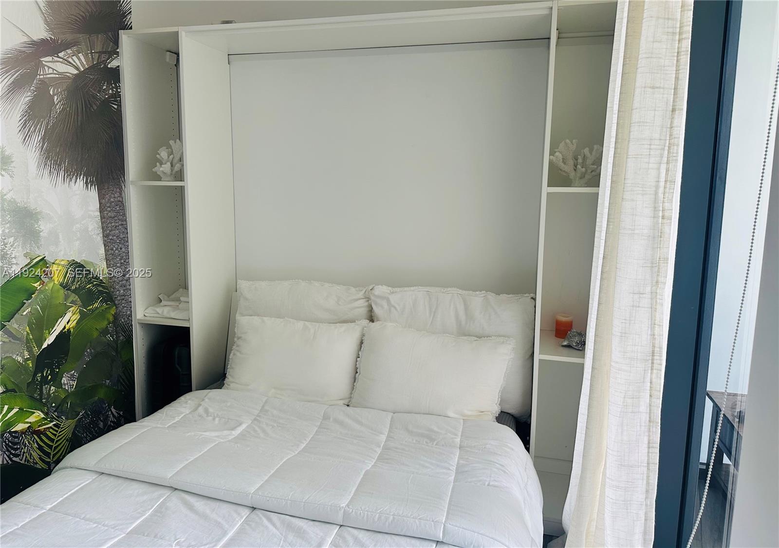 121 Northeast 34th Street, Unit 3014 Miami, FL 33137 - Photo 40 of 54 a bedroom with a bed and a potted plant