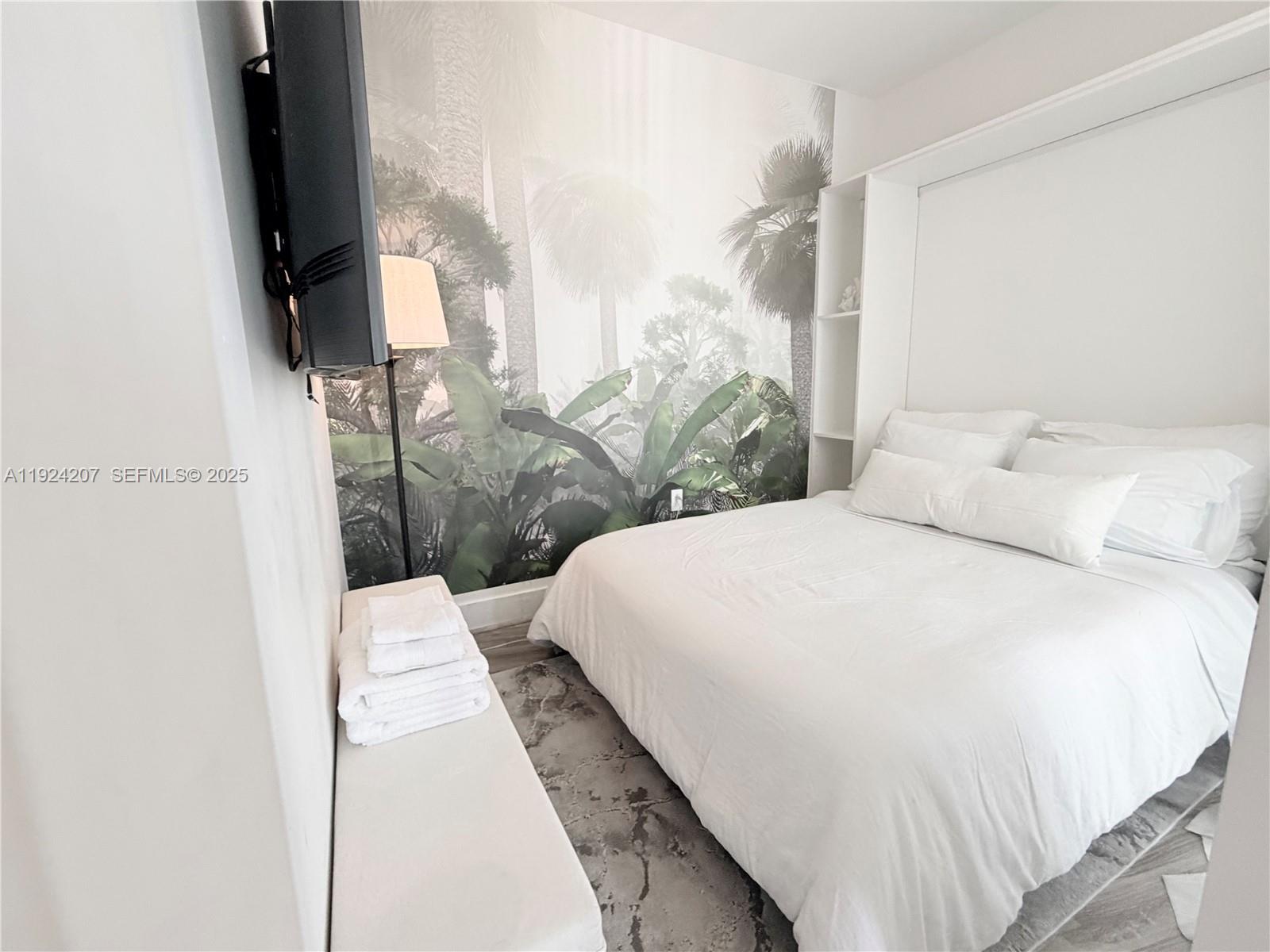 121 Northeast 34th Street, Unit 3014 Miami, FL 33137 - Photo 41 of 54 a large bed sitting in a bedroom next to a window