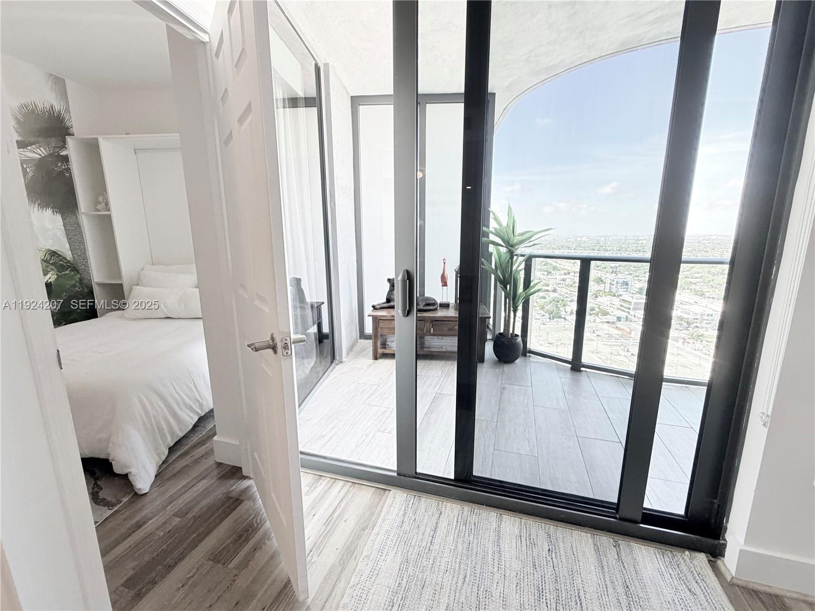 121 Northeast 34th Street, Unit 3014 Miami, FL 33137 - Photo 42 of 54 a view of bedroom with furniture and wooden floor