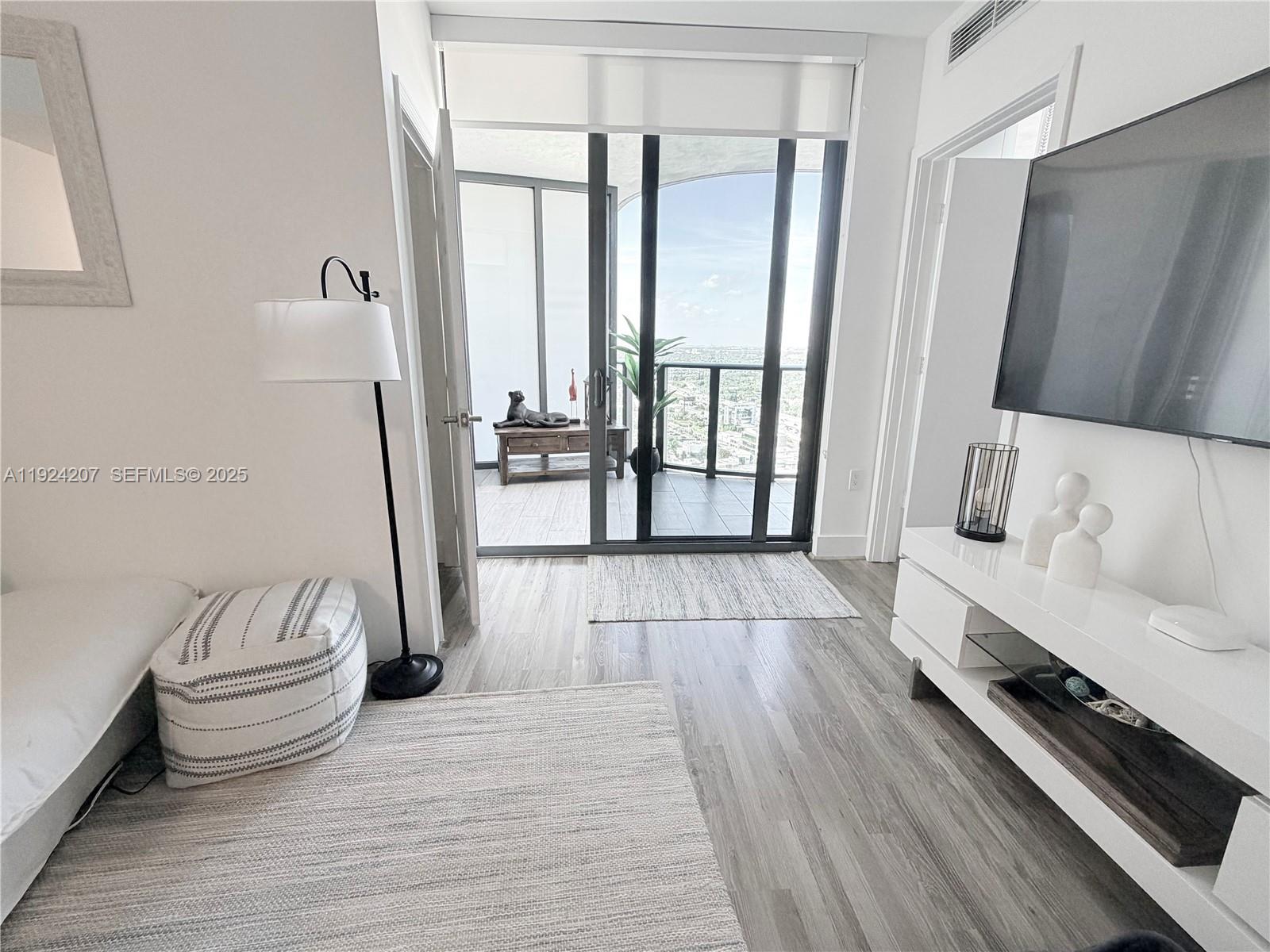 121 Northeast 34th Street, Unit 3014 Miami, FL 33137 - Photo 43 of 54 a spacious bedroom with a bed and a large window