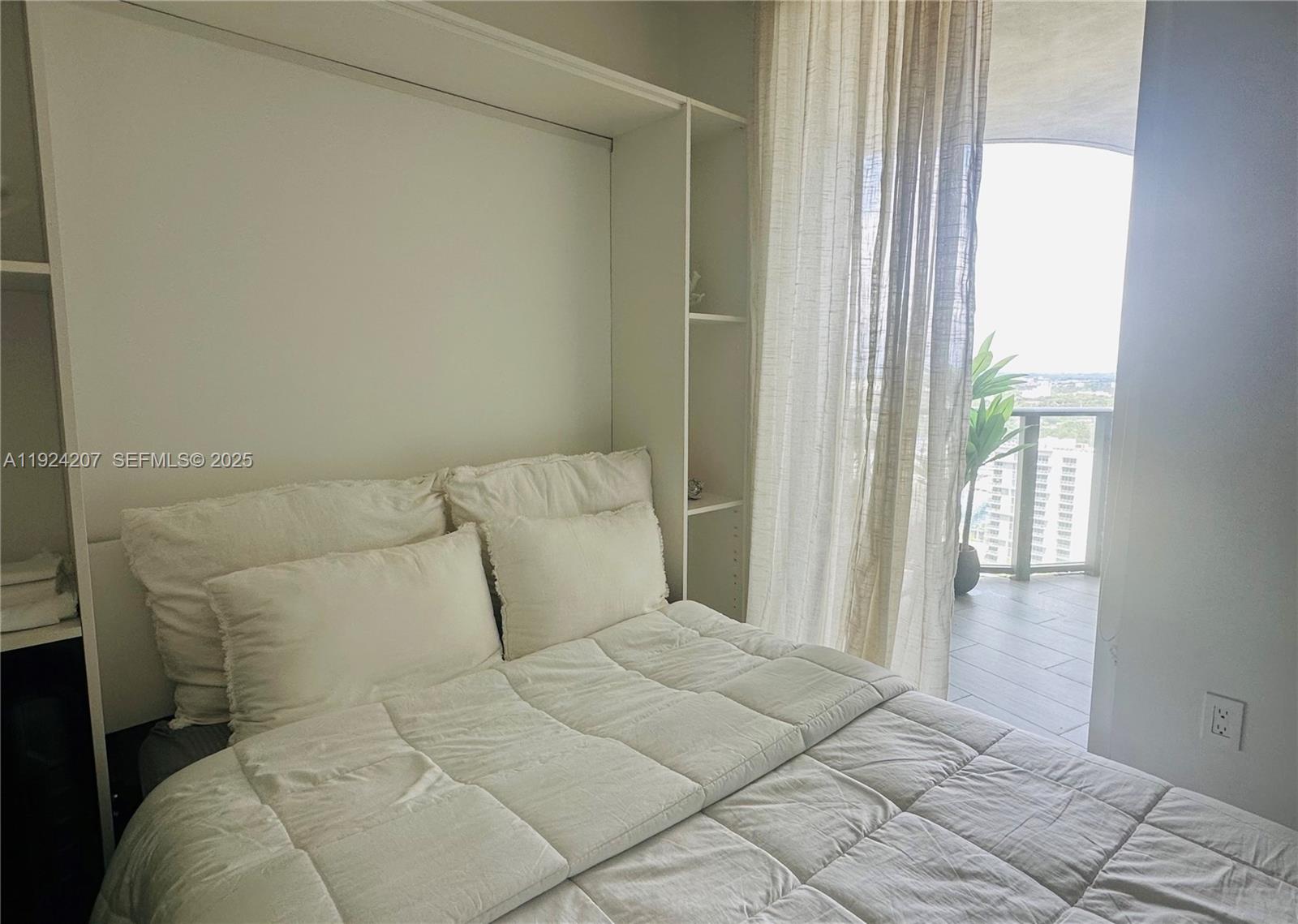 121 Northeast 34th Street, Unit 3014 Miami, FL 33137 - Photo 44 of 54 a bedroom with a bed and a window