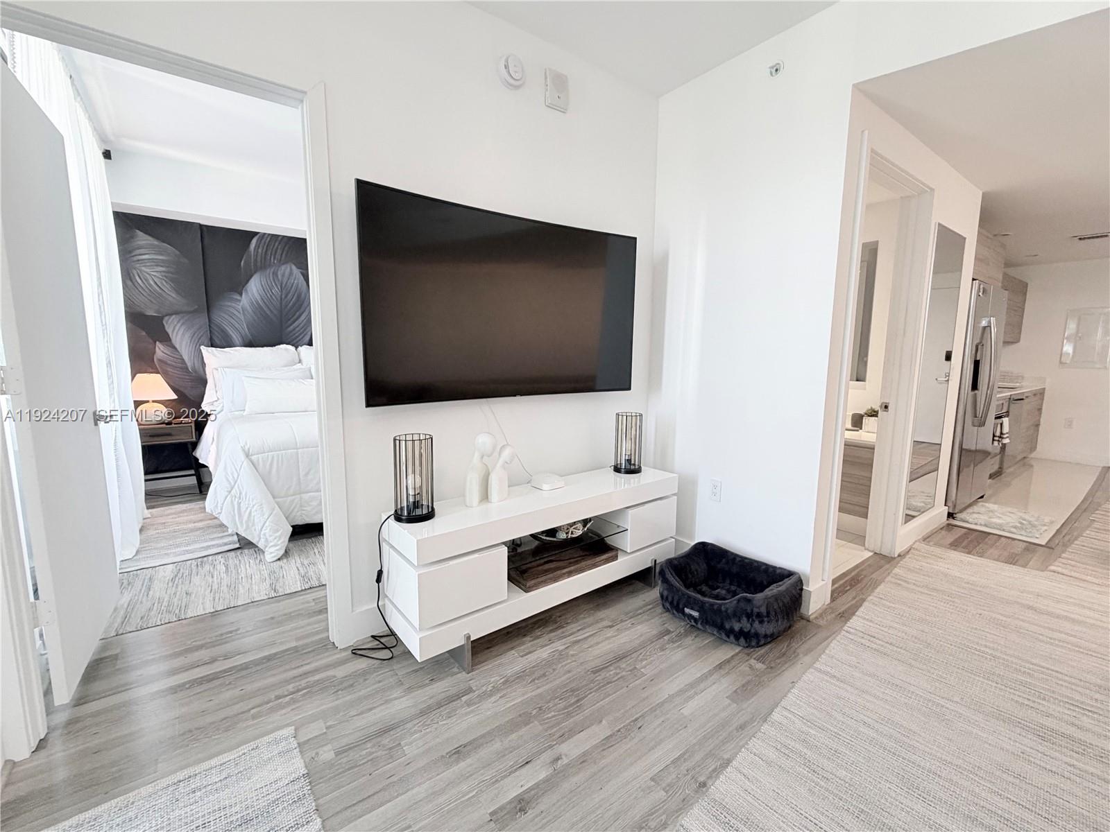 121 Northeast 34th Street, Unit 3014 Miami, FL 33137 - Photo 48 of 54 a living room with furniture and flat screen tv