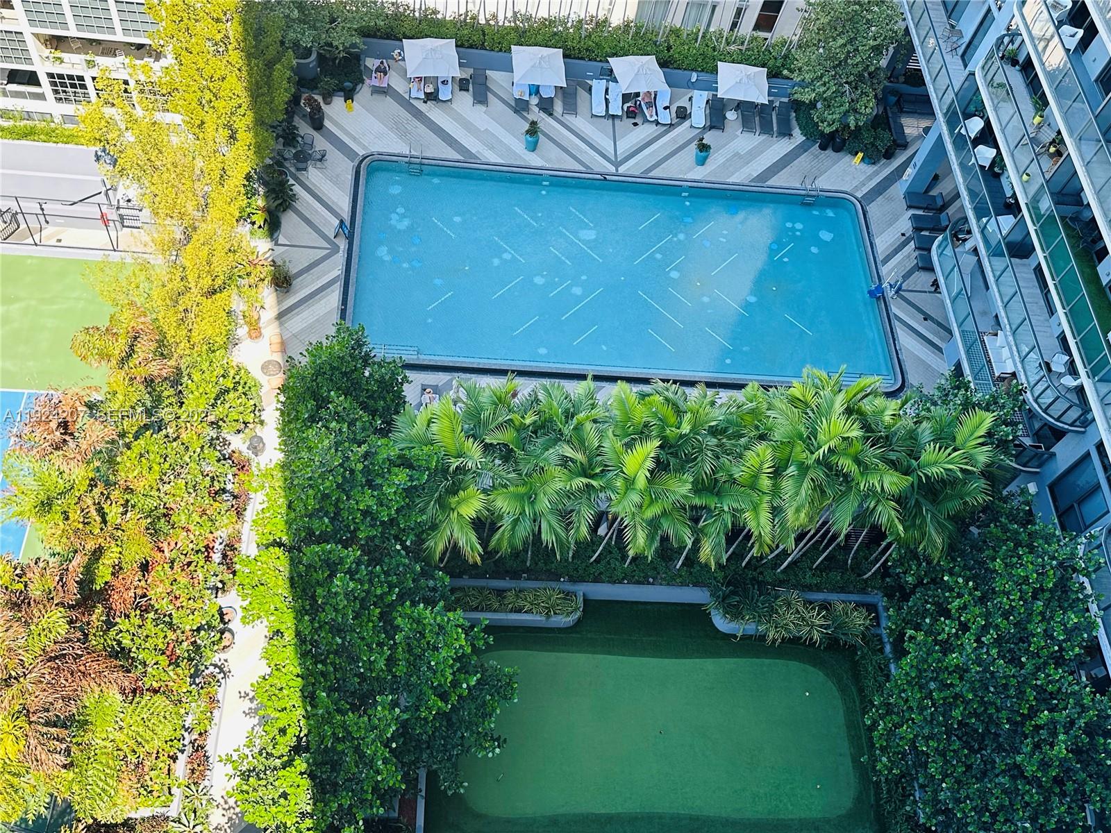 121 Northeast 34th Street, Unit 3014 Miami, FL 33137 - Photo 52 of 54 a view of a wooden bench with potted plants