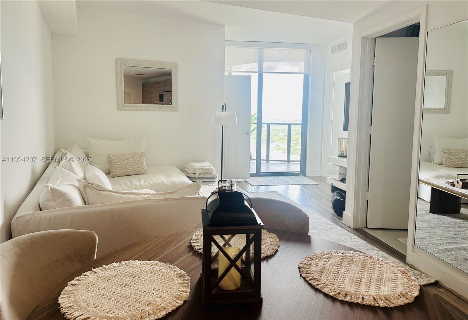 121 Northeast 34th Street, Unit 3014 Miami, FL 33137 - Photo 6 of 54 a living room with furniture and a window