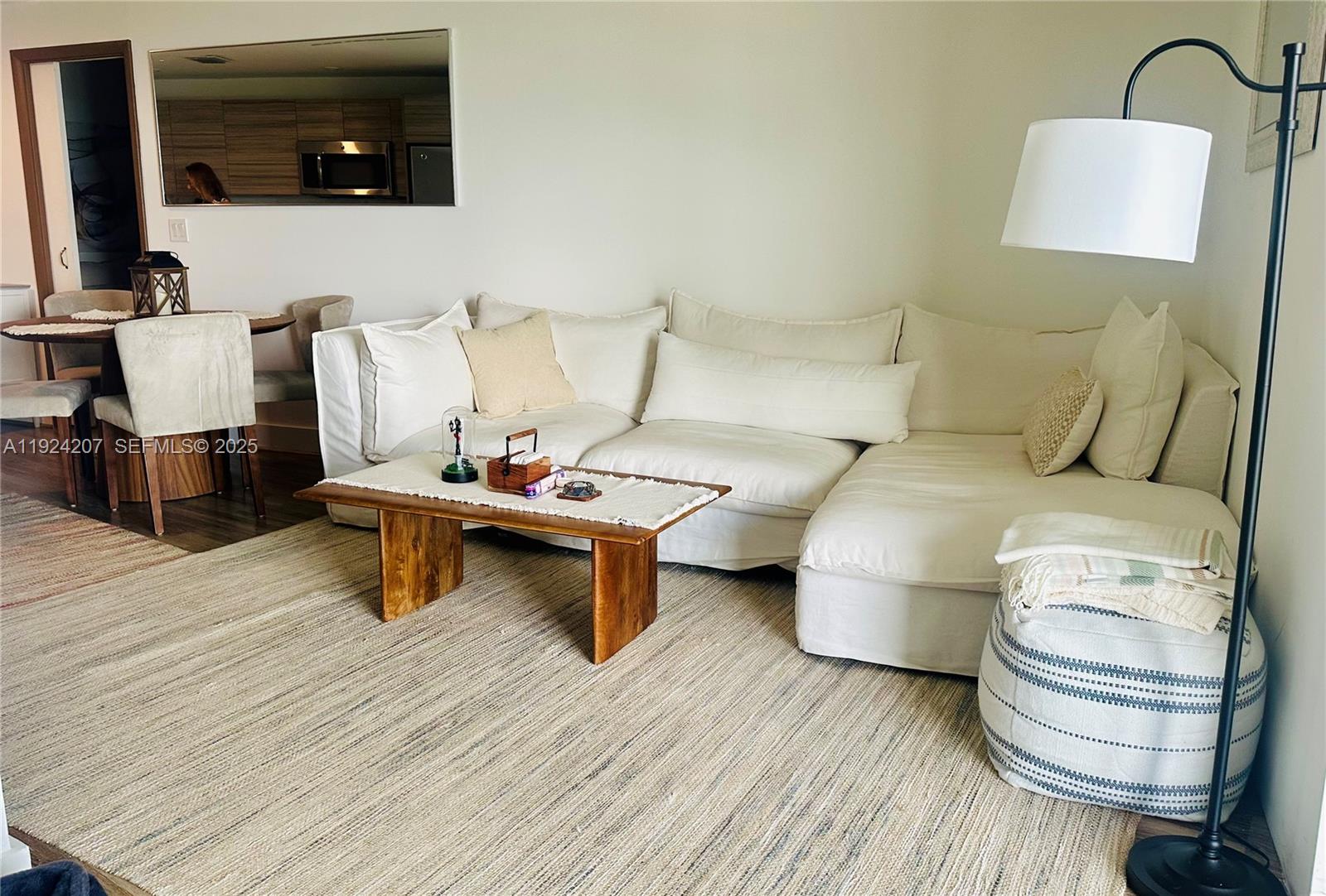 121 Northeast 34th Street, Unit 3014 Miami, FL 33137 - Photo 7 of 54 a living room with furniture and a flat screen tv