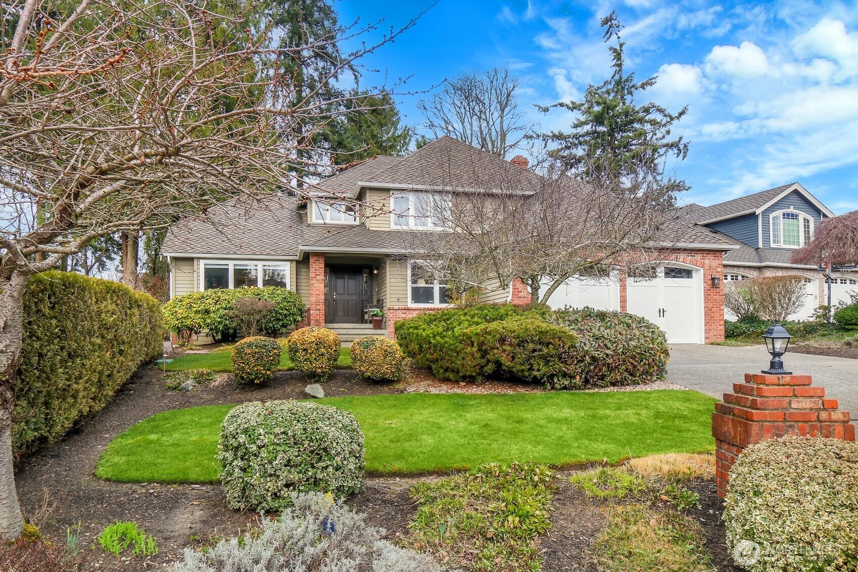 2107 237th Place Southeast Bothell, WA 98021 - Photo 1 of 40 a front view of a house with a garden and plants