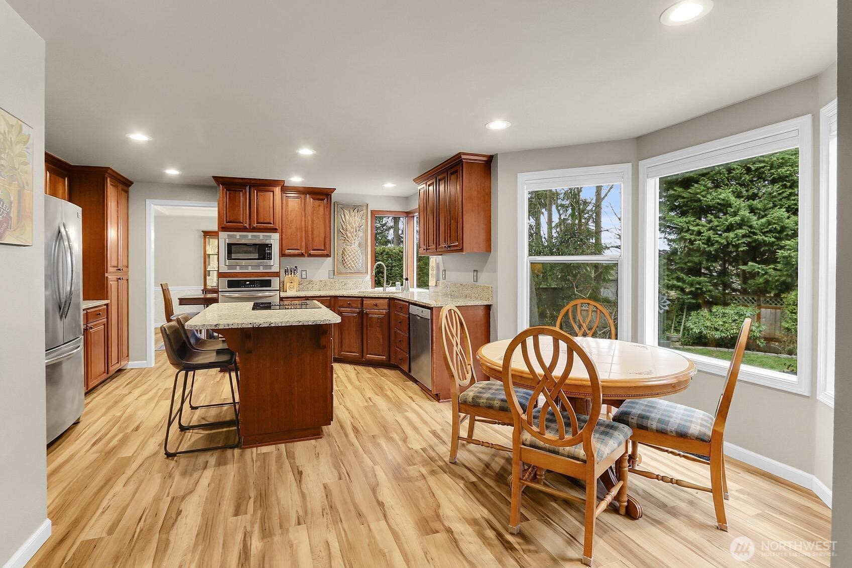 2107 237th Place Southeast Bothell, WA 98021 - Photo 11 of 40 a view of a dining room with furniture window and wooden floor
