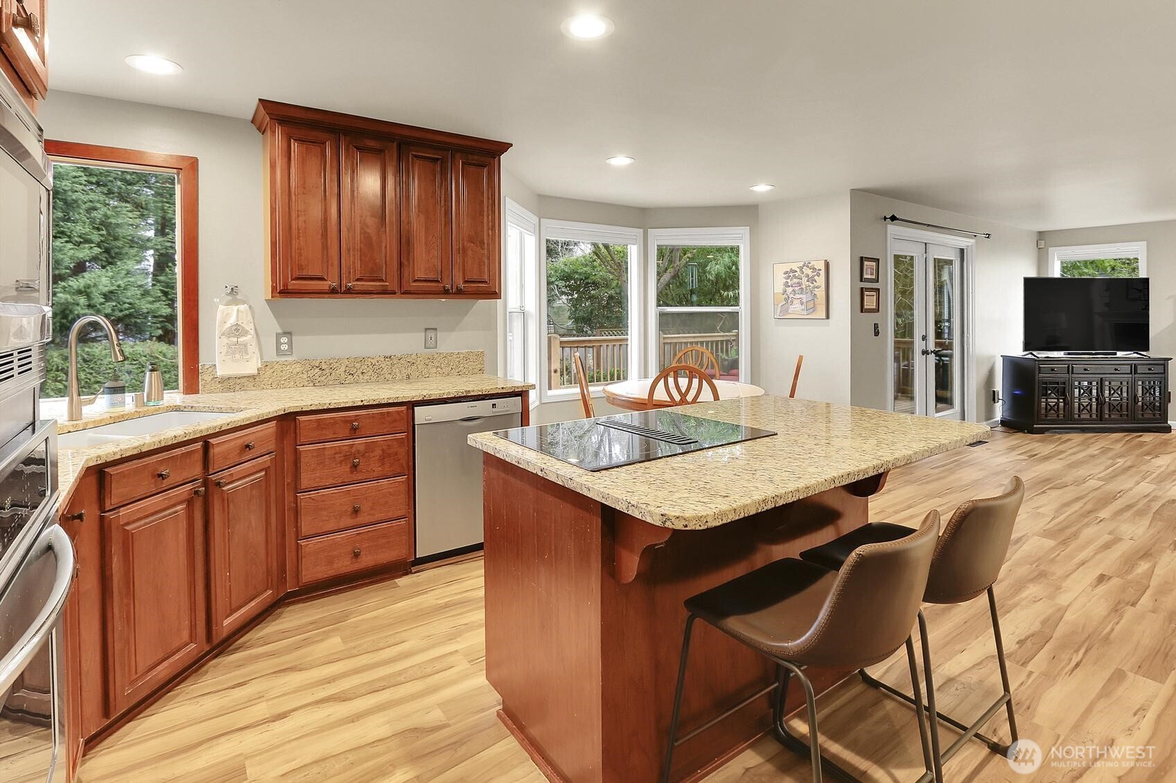 2107 237th Place Southeast Bothell, WA 98021 - Photo 13 of 40 a kitchen with granite countertop a sink and wooden cabinets