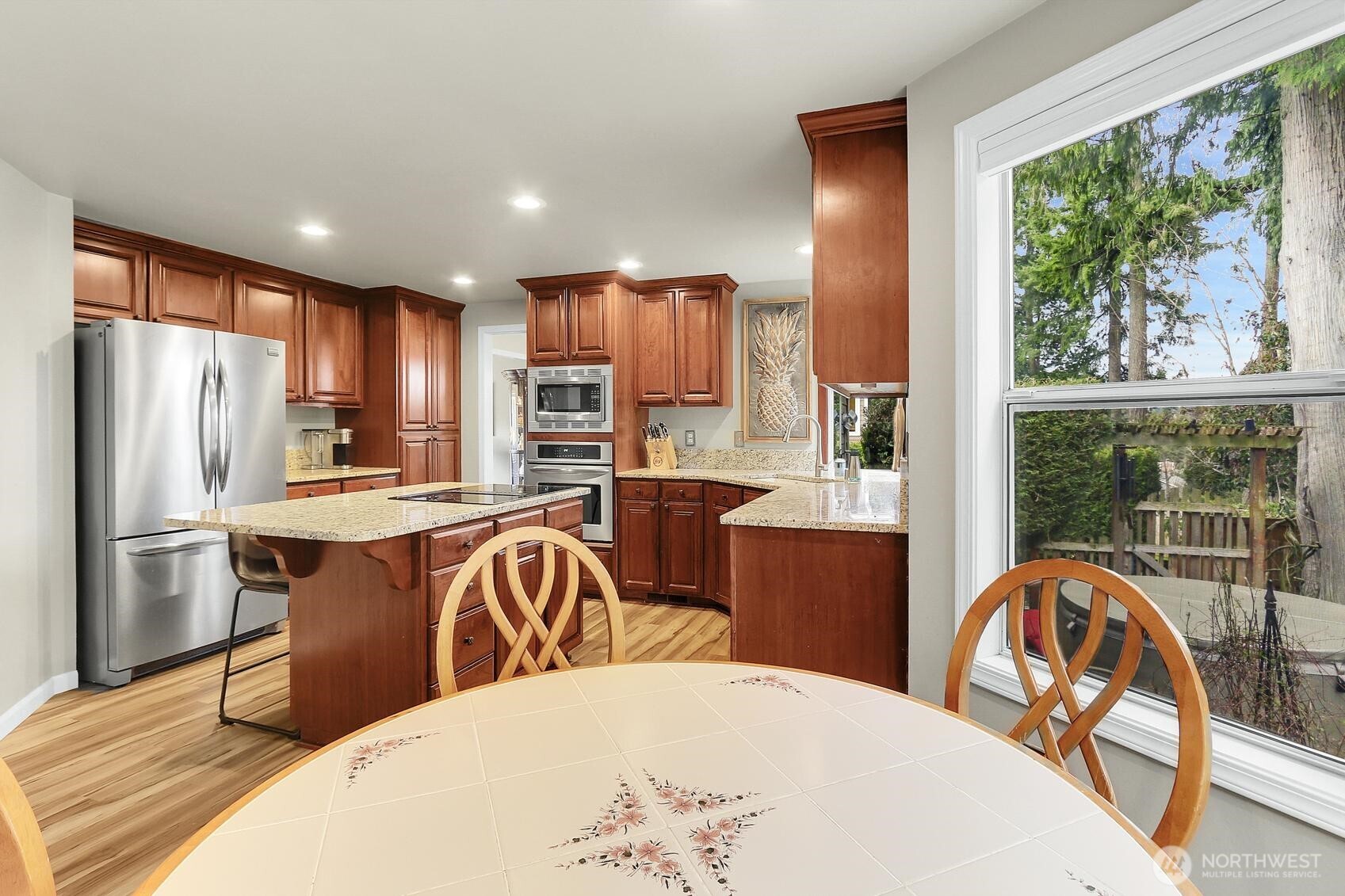 2107 237th Place Southeast Bothell, WA 98021 - Photo 15 of 40 a kitchen with stainless steel appliances a dining table chairs and refrigerator