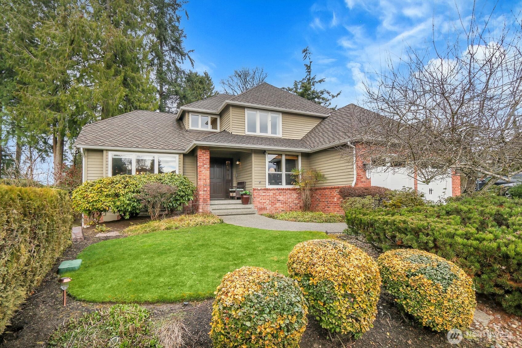 2107 237th Place Southeast Bothell, WA 98021 - Photo 2 of 40 a front view of a house with a garden