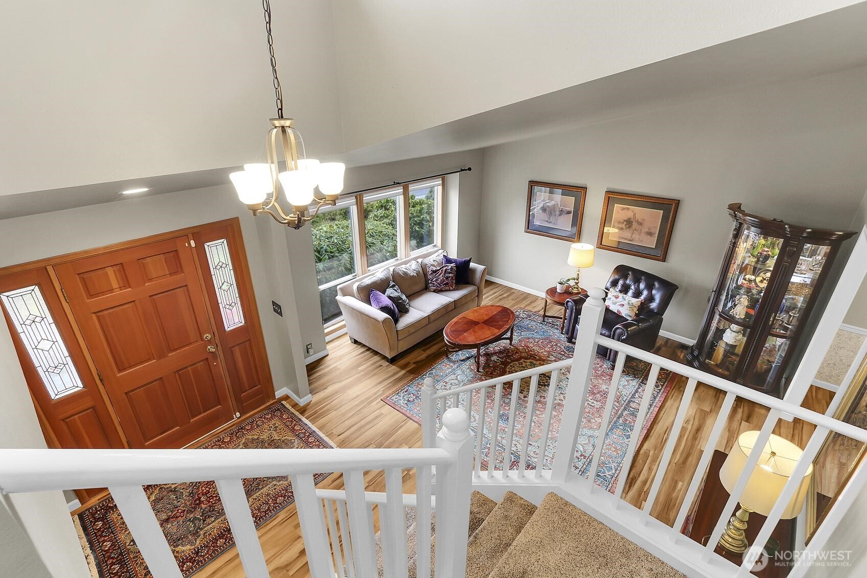 2107 237th Place Southeast Bothell, WA 98021 - Photo 23 of 40 a living room with furniture and a chandelier
