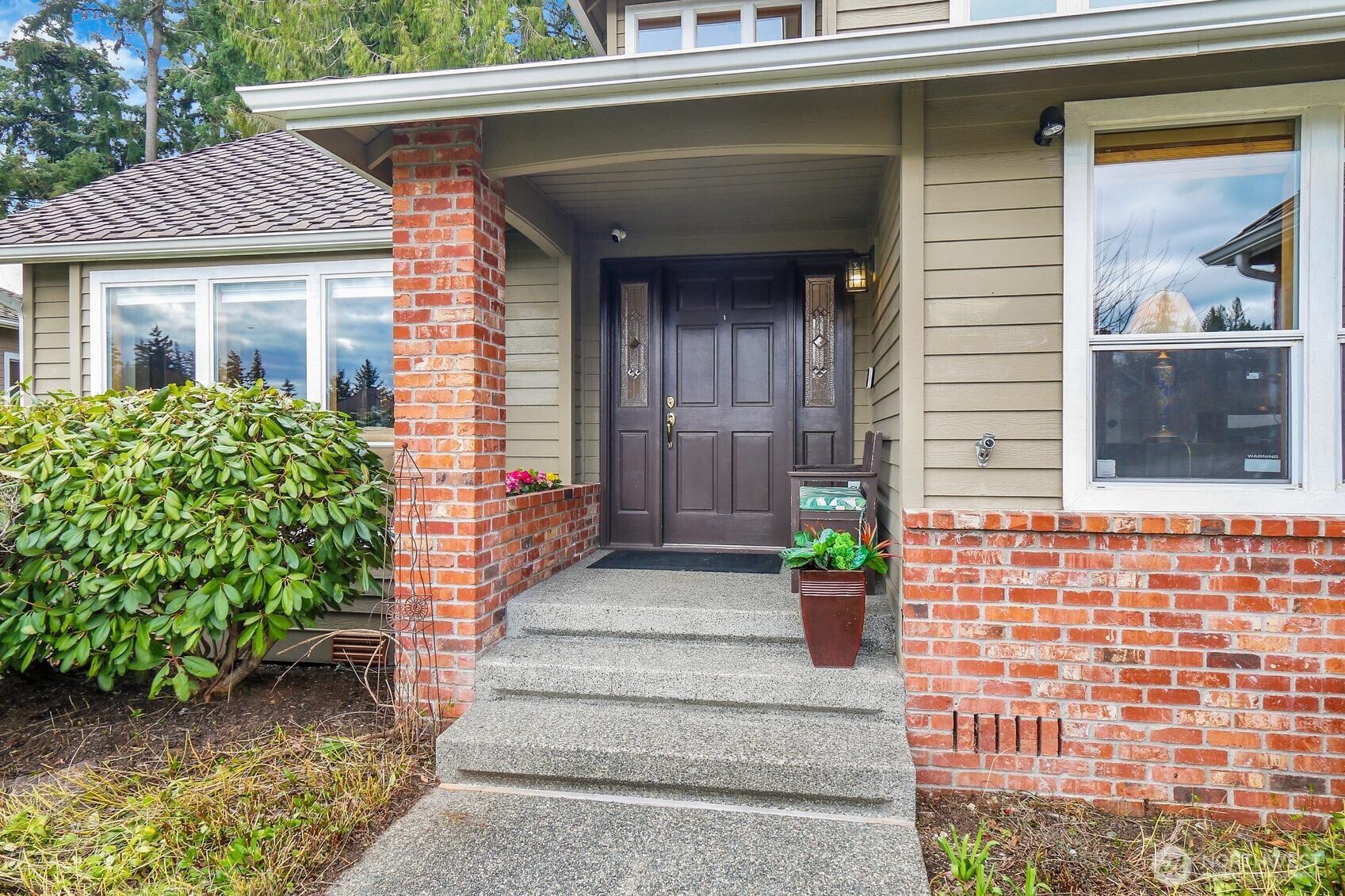 2107 237th Place Southeast Bothell, WA 98021 - Photo 3 of 40 a front view of a house with a garden