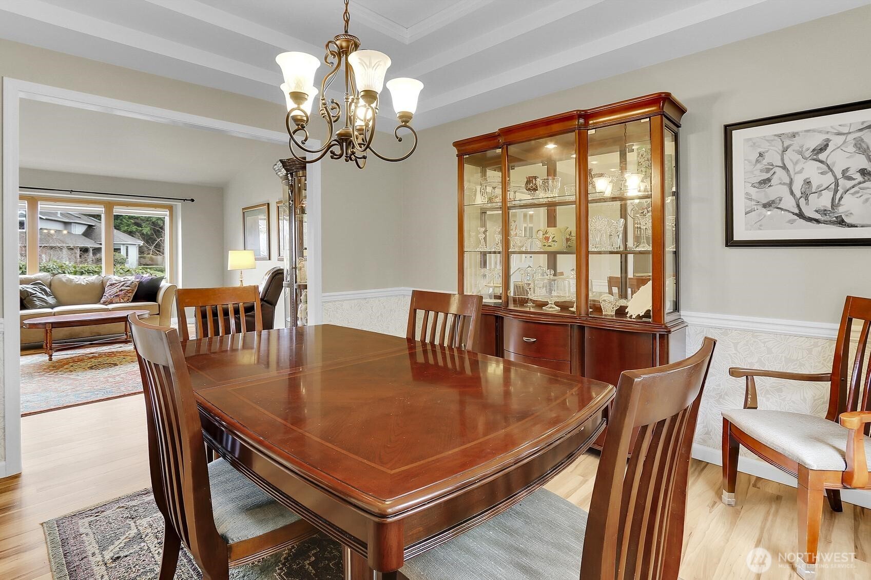 2107 237th Place Southeast Bothell, WA 98021 - Photo 8 of 40 a dining room with wooden floor a chandelier a wooden table and chairs