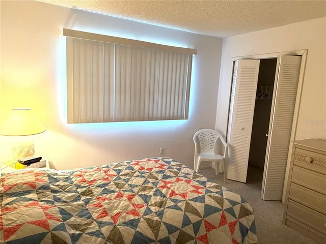 a bedroom with a bed and a chair