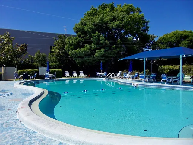a view of a swimming pool with outdoor seating