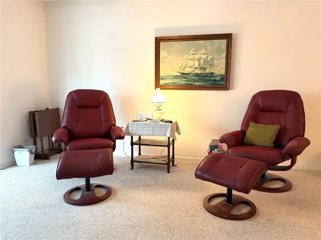 a living room with furniture and a chair