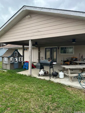 a view of a patio with table and chairs under an umbrella