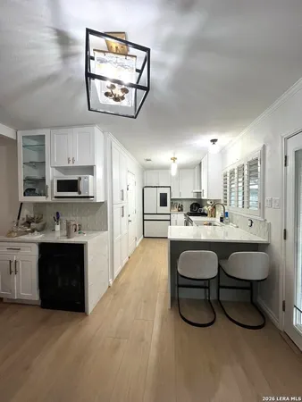a kitchen with stainless steel appliances a stove refrigerator and a sink