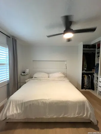 a bedroom with a bed and a tv
