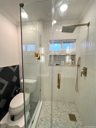 a bathroom with a toilet and a shower