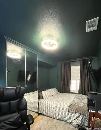 a bedroom with a bed window and walk in closet