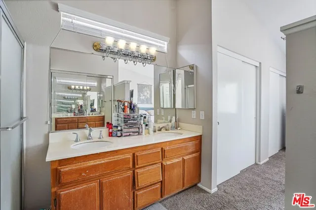 a bathroom with a double vanity sink and a mirror