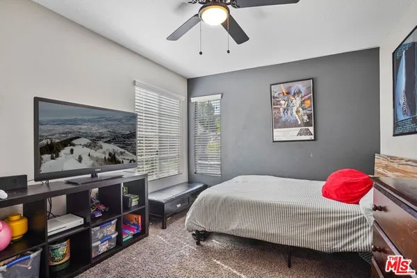 a bedroom with bed and a chandelier