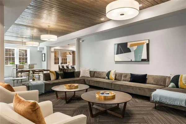 a living room with furniture a rug and a chandelier
