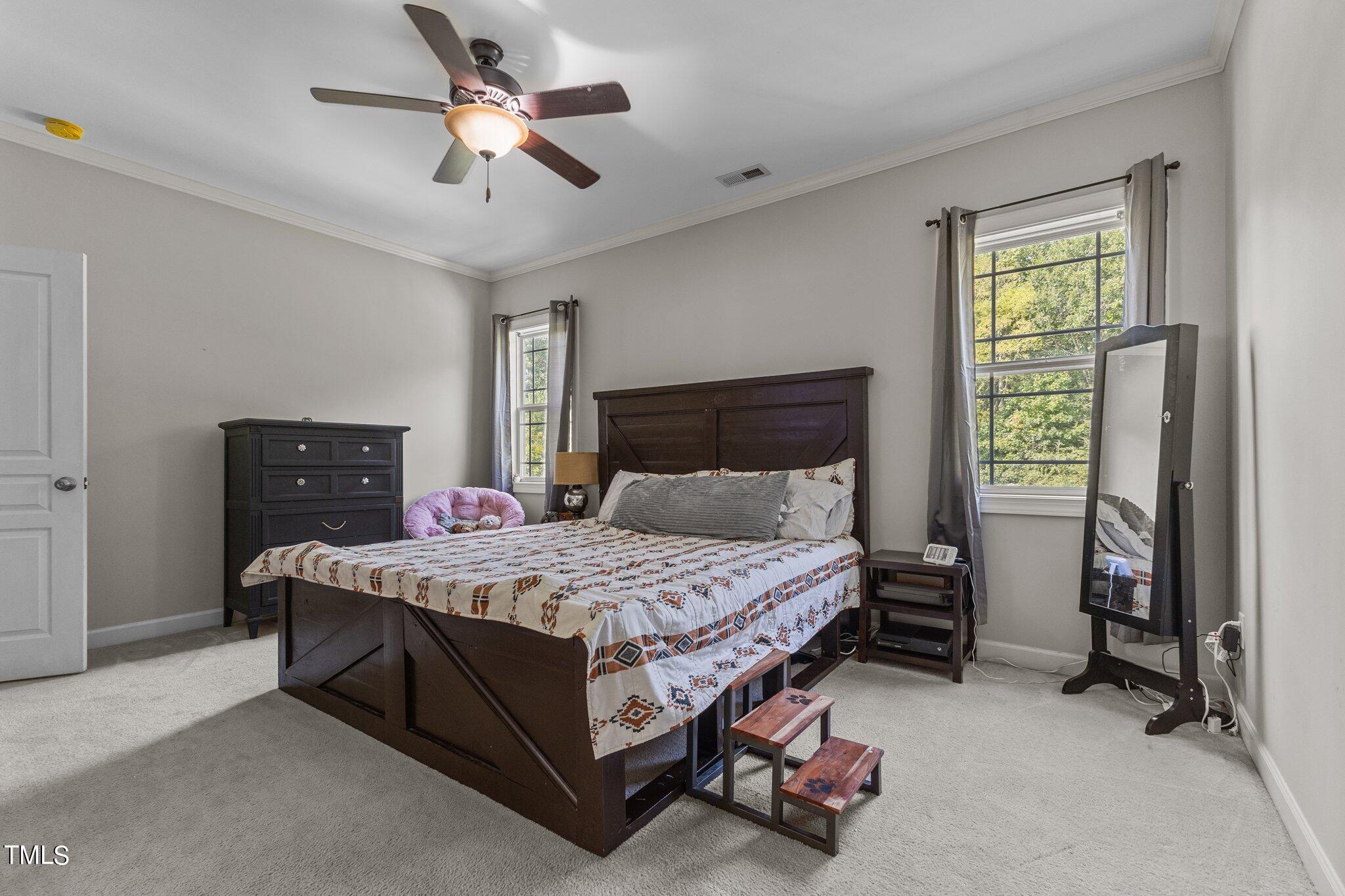 156 Williams Creek Drive Erwin, NC 28339 - Photo 11 of 37 a bedroom with a bed and a chandelier