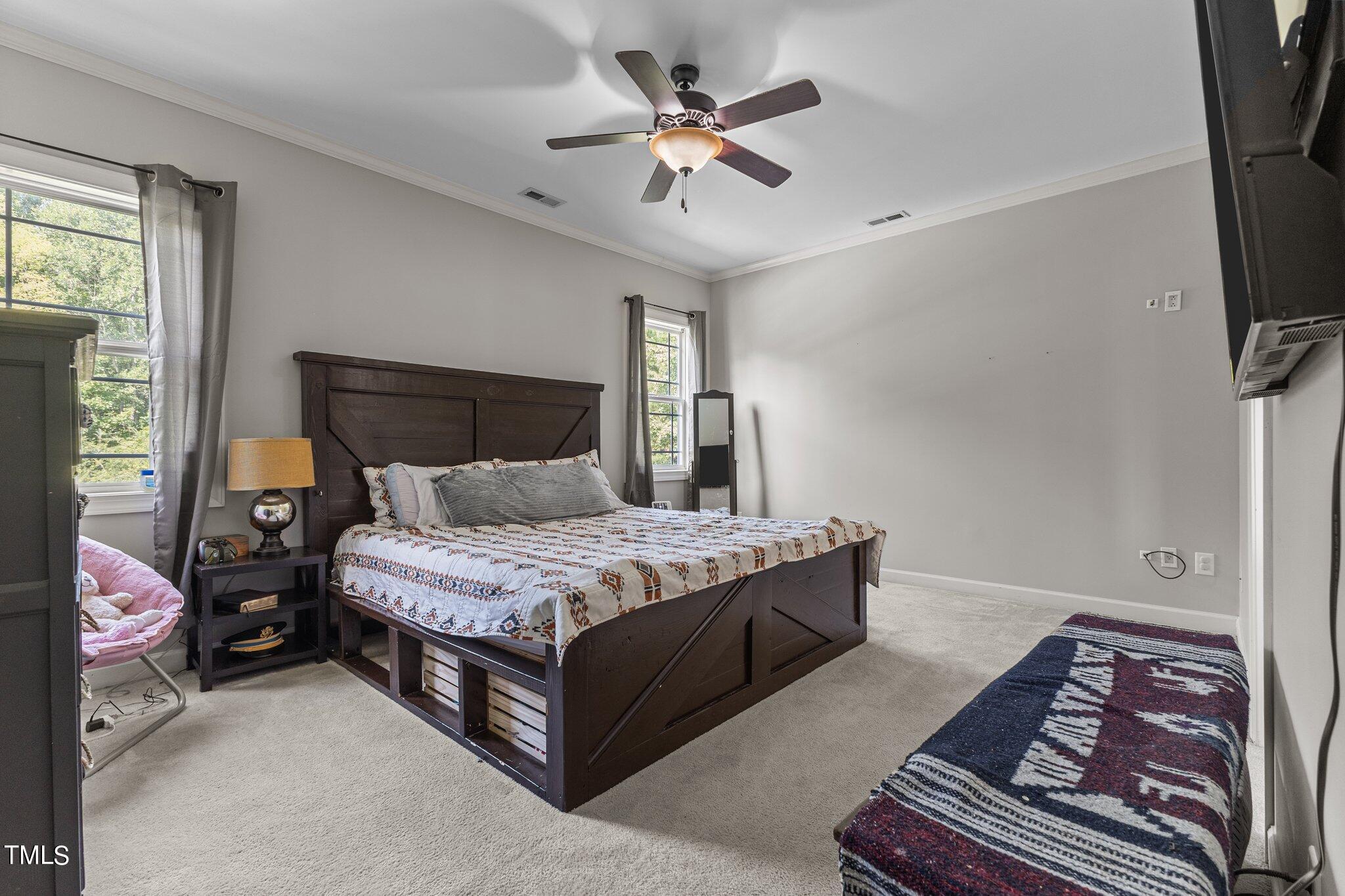 156 Williams Creek Drive Erwin, NC 28339 - Photo 12 of 37 a bedroom with a bed and a chandelier