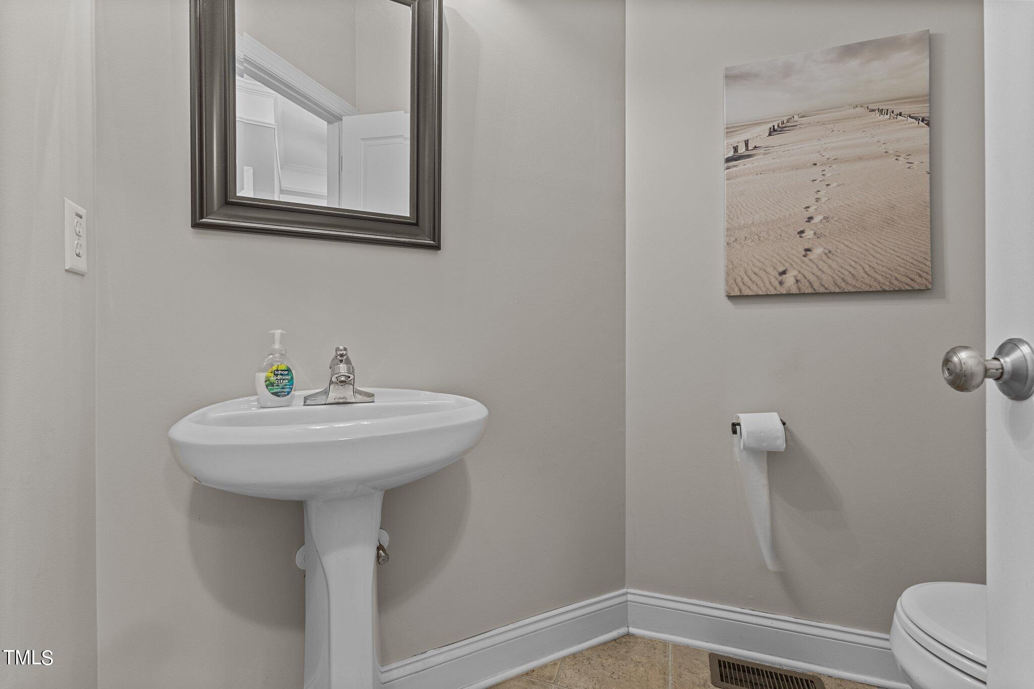 156 Williams Creek Drive Erwin, NC 28339 - Photo 16 of 37 a bathroom with a sink mirror and toilet