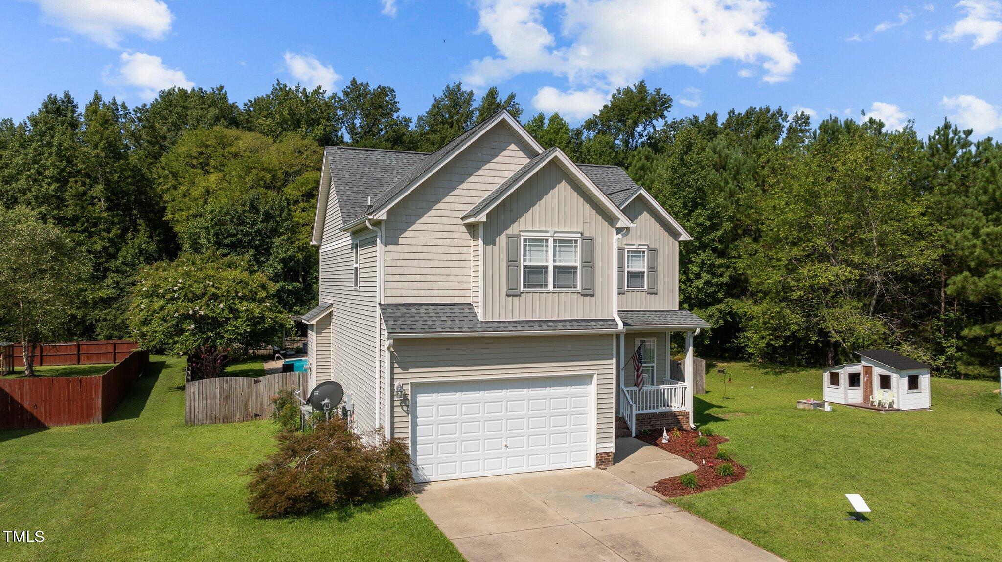156 Williams Creek Drive Erwin, NC 28339 - Photo 30 of 37 a front view of a house with a garden and yard