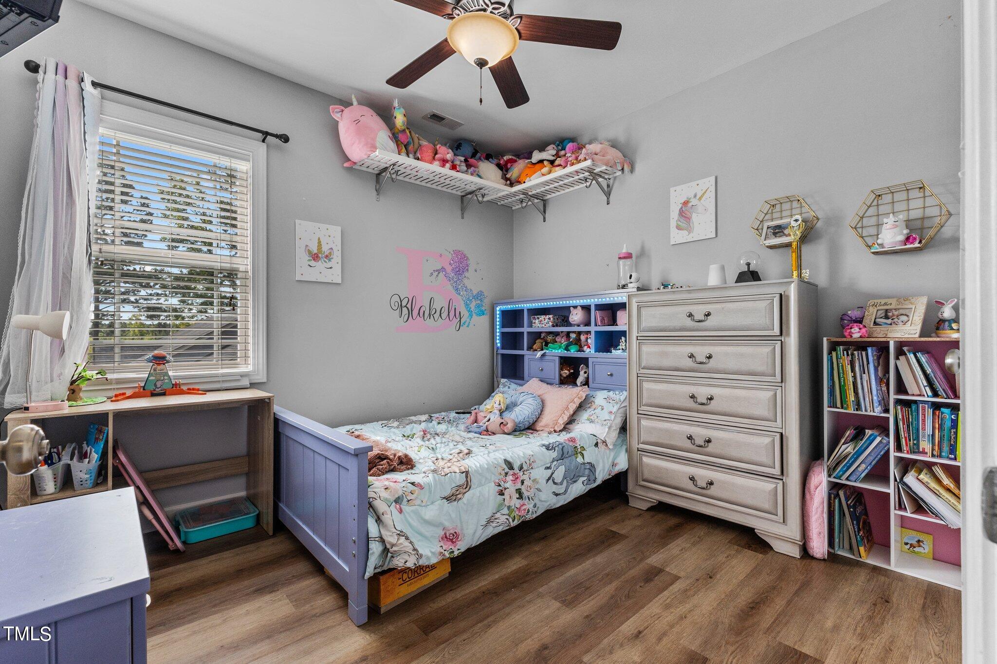 156 Williams Creek Drive Erwin, NC 28339 - Photo 6 of 37 a bedroom with a bed and a book shelf