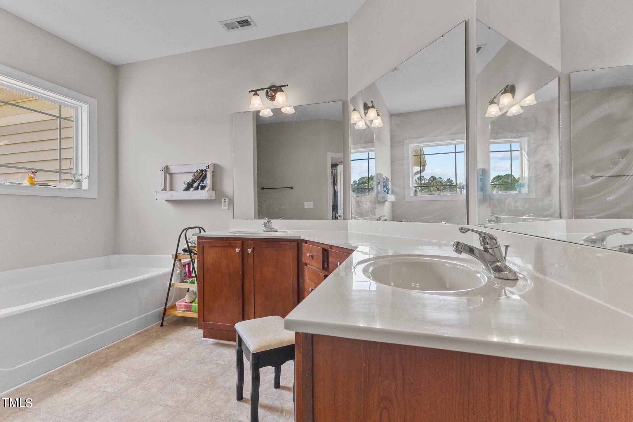 156 Williams Creek Drive Erwin, NC 28339 - Photo 10 of 37 a bathroom with a tub sink and mirror