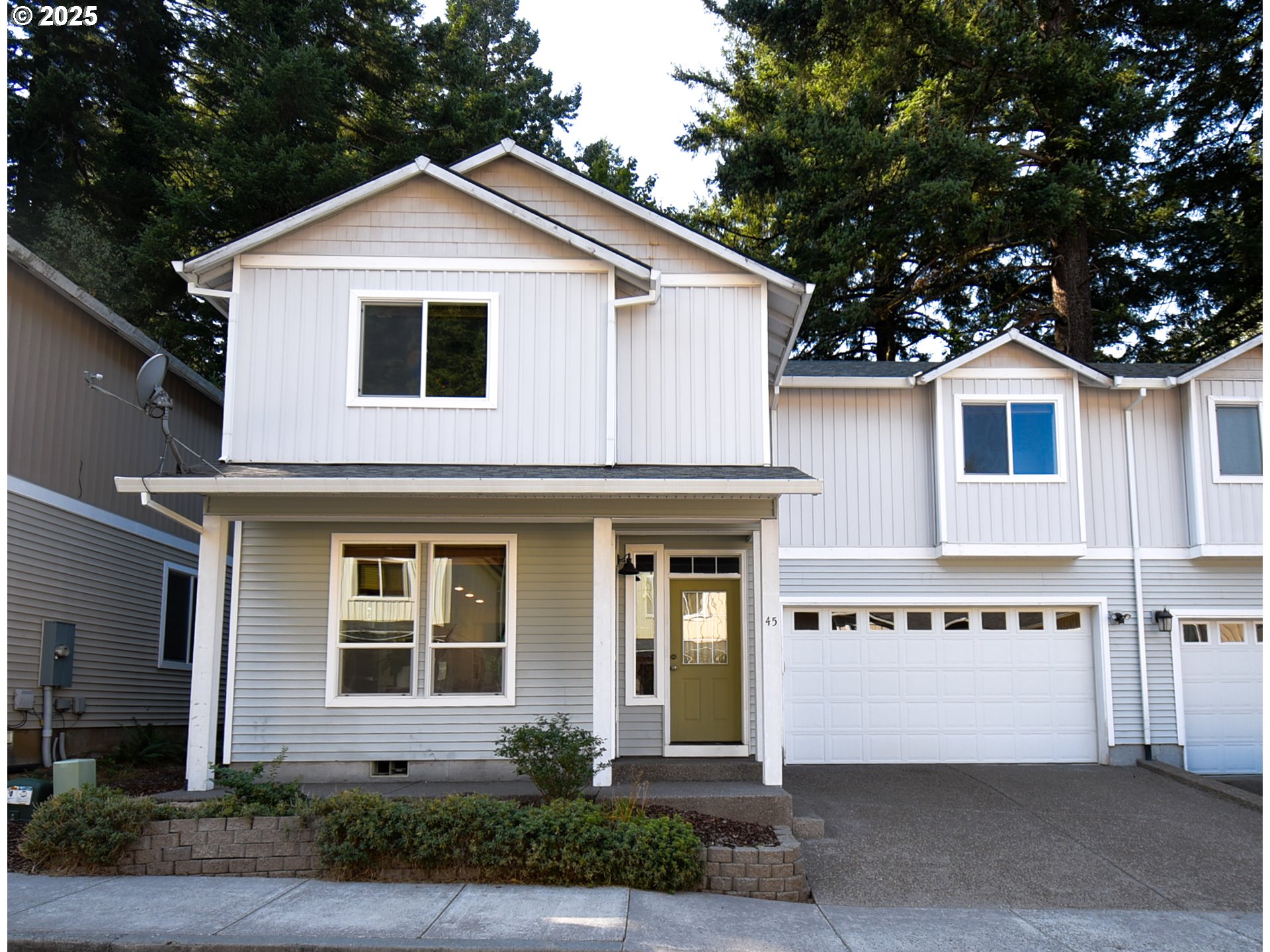 45 Katani Lane Cascade Locks, OR 97014 - Photo 1 of 28 a front view of a house with a yard and garage