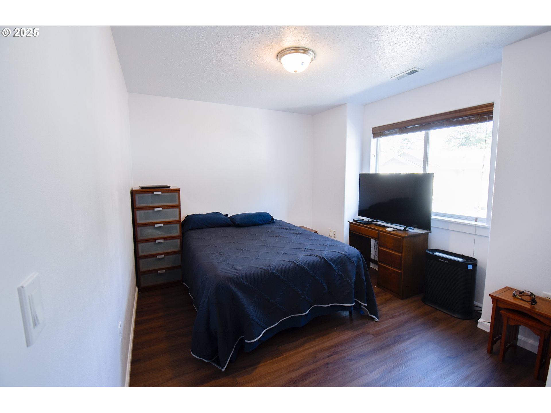 45 Katani Lane Cascade Locks, OR 97014 - Photo 19 of 28 a bedroom with a bed and a flat screen tv