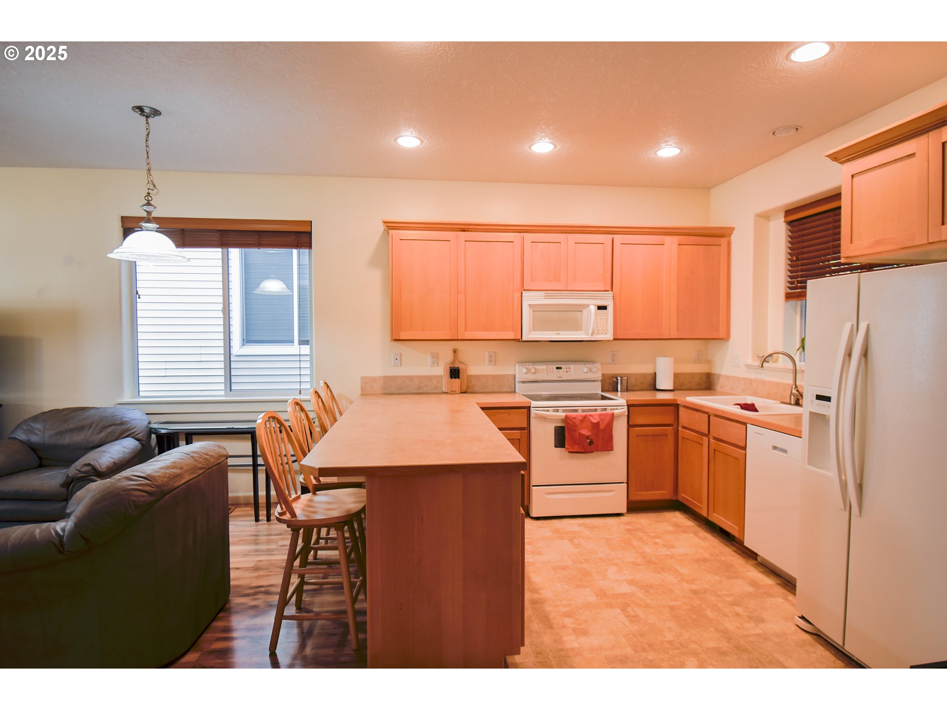 45 Katani Lane Cascade Locks, OR 97014 - Photo 4 of 28 a kitchen with stainless steel appliances granite countertop a stove a sink a refrigerator white cabinets and wooden floor