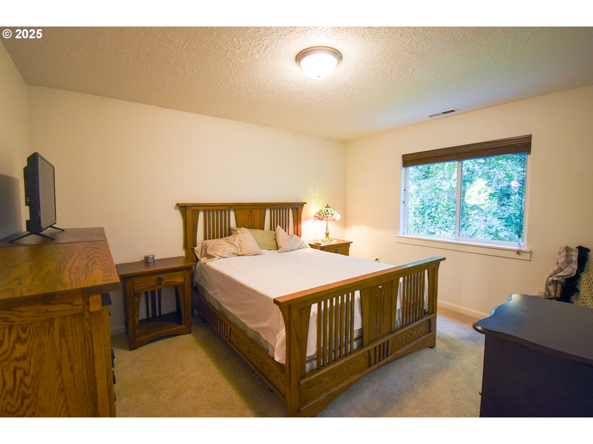 45 Katani Lane Cascade Locks, OR 97014 - Photo 8 of 28 a bedroom with a bed and wooden floor