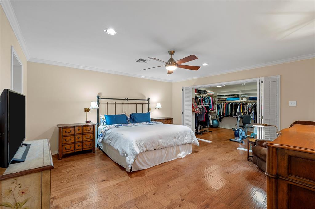3907 Old Mill Road Waco, TX 76710 - Photo 15 of 30 a bedroom with a bed and a flat tv screen on the dresser