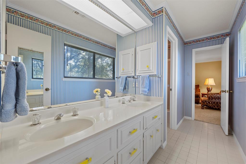 3907 Old Mill Road Waco, TX 76710 - Photo 22 of 30 a spacious bathroom with a double vanity sink and a mirror